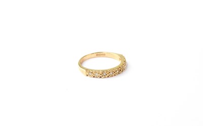 Lot 1064 - A 9ct gold half eternity ring set with nine...