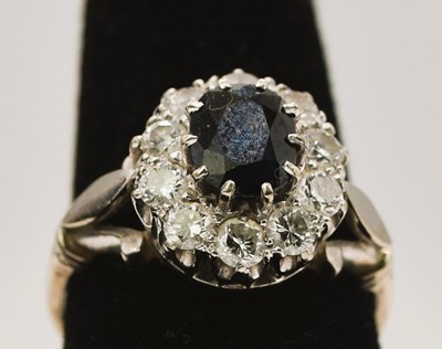 Lot 579 - A white metal sapphire and diamond oval...