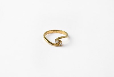 Lot 1053 - A 9ct gold ring set with two diamonds in a...