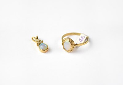 Lot 1209 - A 9ct gold pendant set with an opal and three...