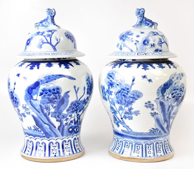 Lot 150 - A large pair of blue and white baluster lidded...