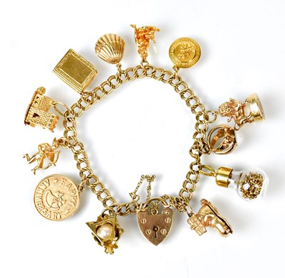 Lot 1082 - A 9ct yellow gold charm bracelet with...