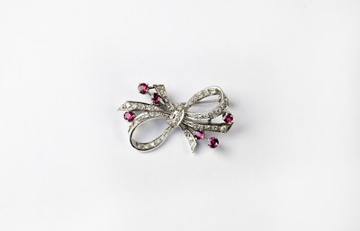 Lot 1150 - A white metal diamond and ruby set brooch in...