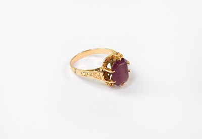 Lot 1083 - A gold ring set with amethyst and floral...