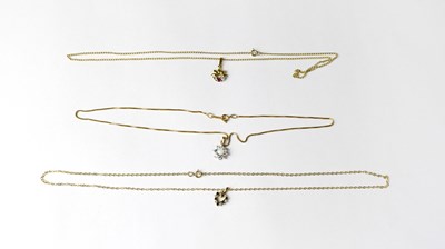 Lot 1174 - Three pendant necklaces comprising a 9ct gold...