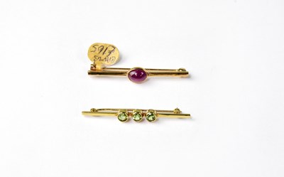 Lot 1138 - Two 9ct gold bar brooches, one set with three...
