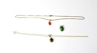 Lot 1173 - Three 9ct gold pendants, each set with a...