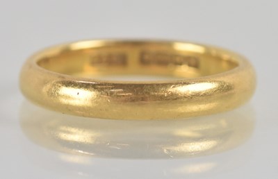 Lot 1194 - A 22ct yellow gold wedding band, size K/L,...