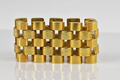 Lot 1095 - A yellow metal open work bracelet, set with...