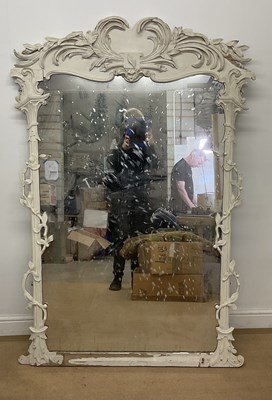 Lot 2787 - A large carved wooden painted mirror, ornately...