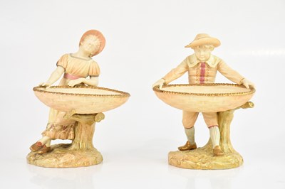 Lot 1865 - ROYAL WORCESTER; a pair of blush ivory figures,...