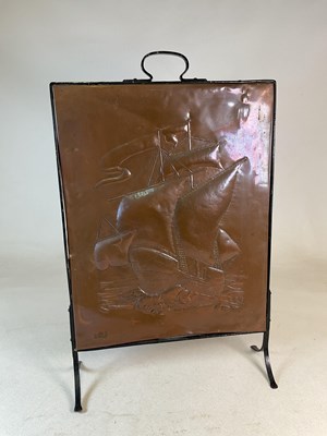 Lot 119 - A copper fire screen decotated with a low...