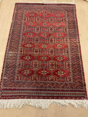 Lot 2746 - An Afghan rug with a geometric border and...