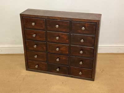 Lot 2794 - A stained wood bank of fifteen drawers with...