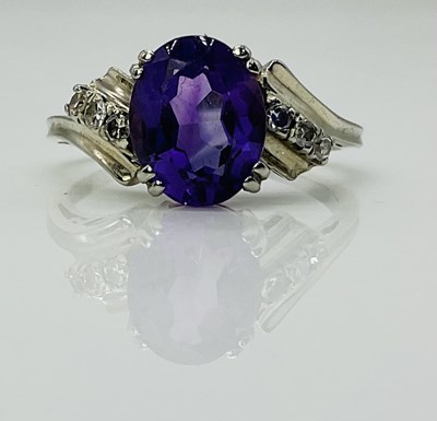 Lot 573 - An 18ct white gold amethyst dress ring, size R...