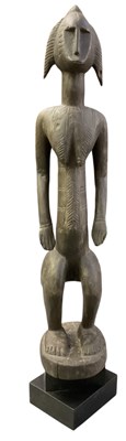 Lot 1004 - An African carved wooden tribal Hemba male...