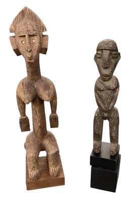 Lot 1022 - Two African carved wooden tribal figures,...