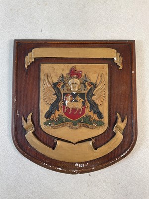 Lot 196 - A simulated oak painted plaster shield shaped...
