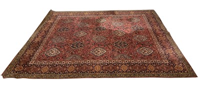 Lot 1210 - A red ground Eastern style carpet, with floral...