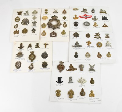Lot 1223 - A collection of WWI and later military cap and...