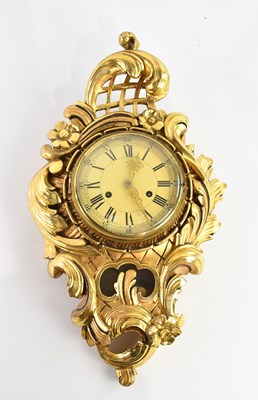 Lot 368 - A Swedish giltwood cartel wall clock in the...