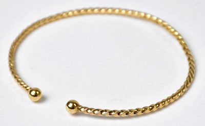 Lot 1059 - A 9ct yellow gold twist torc bangle, approx. 7....