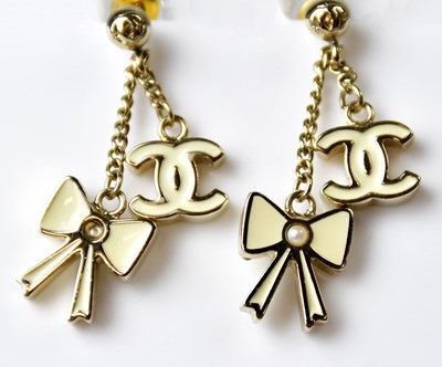 Lot 1116 - CHANEL; a pair of stud earrings with double...