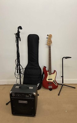Lot 2385 - FENDER; Squier bass guitar, stand, carriage...