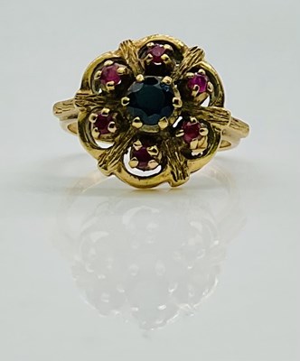 Lot 614 - A 9ct yellow gold sapphire and ruby flower...