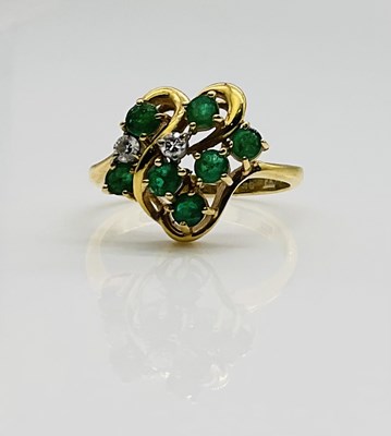 Lot 633 - An 18ct yellow gold emerald and diamond ring,...