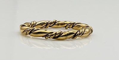 Lot 635 - A 9ct yellow gold twisted wedding band, size L...