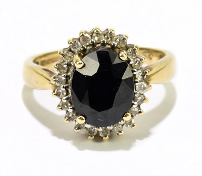 Lot 1054 - A 9ct yellow gold sapphire and diamond ring,...