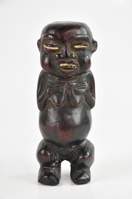 Lot 1549 - A carved hardwood tribal figure with white...