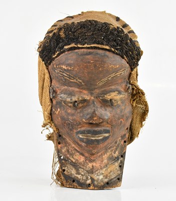 Lot 1520 - A west African carved mask with hand painted...