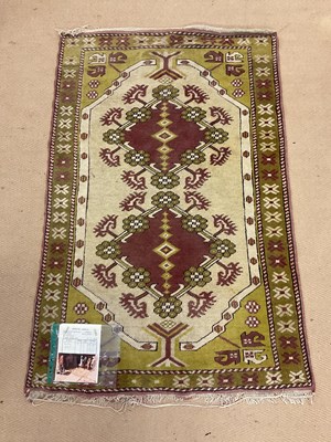 Lot 2743 - A Turkish rug, with cream ground central panel...