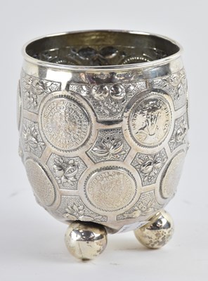 Lot 1131 - A 930 grade silver coin set beaker, raised on...