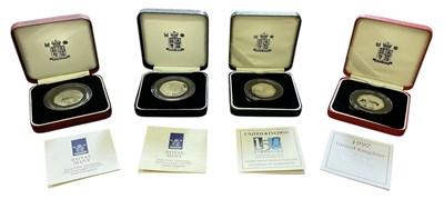 Lot 1383 - THE ROYAL MINT; four silver fifty pence coins...