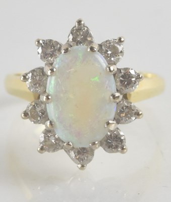 Lot 1187 - An 18ct yellow gold opal and diamond cluster...