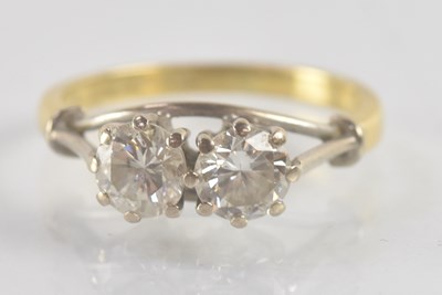 Lot 1190 - An 18ct yellow gold diamond two stone ring,...