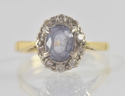 Lot 1183 - An 18ct yellow gold Ceylon sapphire and...