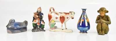 Lot 1774 - A majolica glazed model of a seated monkey,...