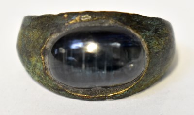 Lot 1042 - A Roman ring set with an oval blue stone...