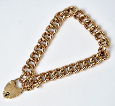 Lot 1051 - A 9ct yellow gold curb link bracelet, with...