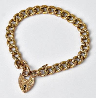 Lot 1052 - A 9ct yellow gold 'day and night' curb link...