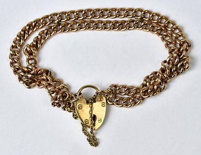 Lot 1053 - A 9ct yellow gold double-strand curb link...
