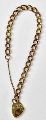 Lot 1056 - A 9ct yellow gold curb link bracelet with a...