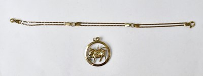 Lot 1121 - A 9ct yellow gold circular Taurus pendant set...