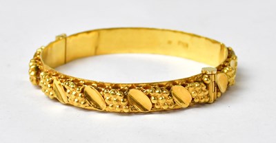 Lot 1045 - A Chinese gold bracelet with applied relief...