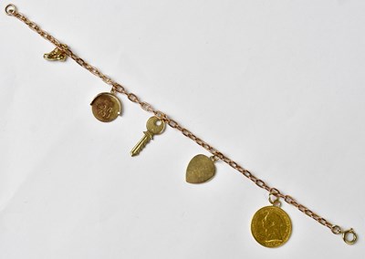 Lot 1057 - A 9ct yellow gold charm bracelet set with four...