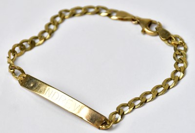 Lot 1055 - A 9ct yellow gold flat curb link identity...
